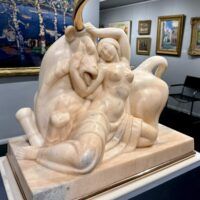 Alt text: Marble sculpture of a woman and a bull with bronze horns