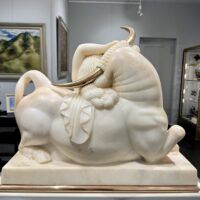 Alt text: Marble sculpture of a woman and a bull with bronze horns