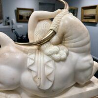 Alt text: Marble sculpture of a woman and a bull with bronze horns