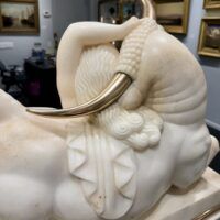 Alt text: Marble sculpture of a woman and a bull with bronze horns