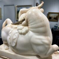 Alt text: Marble sculpture of a woman and a bull with bronze horns