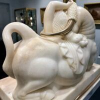 Alt text: Marble sculpture of a woman and a bull with bronze horns