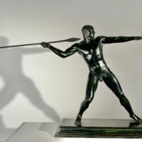 Alt text: Bronze sculpture of man with a spear