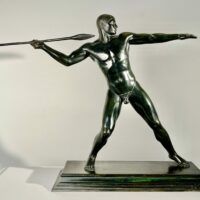 Alt text: Bronze sculpture of man with a spear