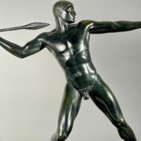 Alt text: Bronze sculpture of man with a spear