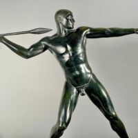 Alt text: Bronze sculpture of man with a spear