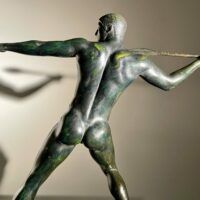 Alt text: Bronze sculpture of man with a spear