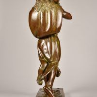 Alt text: Bronze sculpture of Hercules cloaked in a lion skin holding a raised club