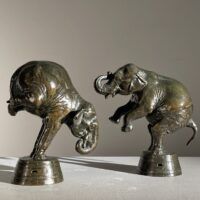 Alt text: A pair of bronze sculptures depicting circus elephants