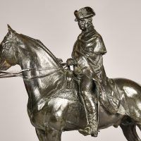 Alt text: Bronze sculpture of George Washington sitting atop his horse, angled detail view