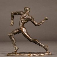 Alt text: Small bronze sculpture of an athlete caught in motion throwing with right arm, side view