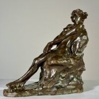 Alt text: Bronze sculpture of a nude woman sitting and reclining