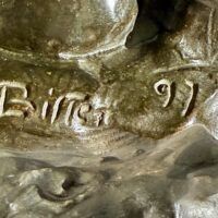 Alt text: Bronze sculpture of a nude woman sitting and reclining