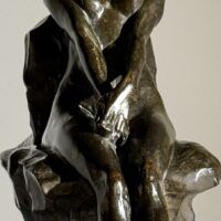 Alt text: Bronze sculpture of a nude woman sitting and reclining