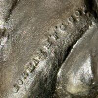 Alt text: Bronze sculpture of a nude woman sitting and reclining