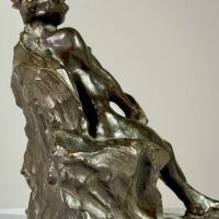 Alt text: Bronze sculpture of a nude woman sitting and reclining