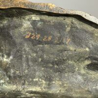 Alt text: Bronze sculpture, underside detail