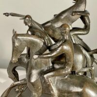 Alt text: bronze sculpture of three men on horseback