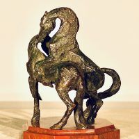 Alt text: Bronze sculpture of two stallions fighting, angled view