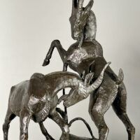 Alt text: Bronze sculpture of two goats