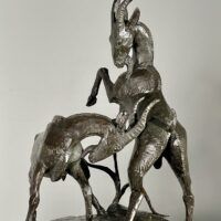 Alt text: Bronze sculpture of two goats