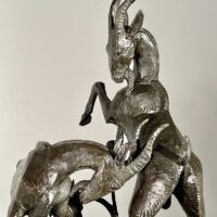 Alt text: Bronze sculpture of two goats