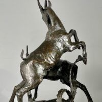 Alt text: Bronze sculpture of two goats