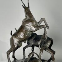 Alt text: Bronze sculpture of two goats