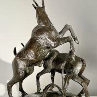 Alt text: Bronze sculpture of two goats