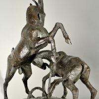 Alt text: Bronze sculpture of two goats