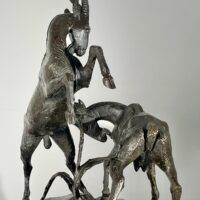 Alt text: Bronze sculpture of two goats