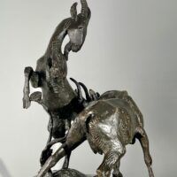 Alt text: Bronze sculpture of two goats