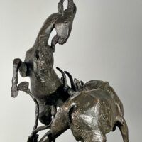 Alt text: Bronze sculpture of two goats