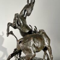 Alt text: Bronze sculpture of two goats