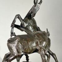 Alt text: Bronze sculpture of two goats