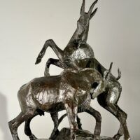 Alt text: Bronze sculpture of two goats