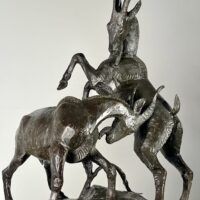 Alt text: Bronze sculpture of two goats