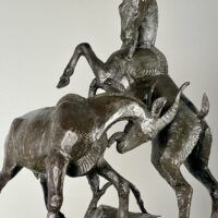 Alt text: Bronze sculpture of two goats