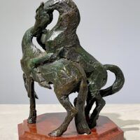 Alt text: Bronze sculpture of two stallions fighting