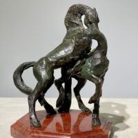 Alt text: Bronze sculpture of two stallions fighting