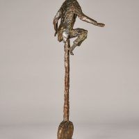 Alt text: Bronze sculpture of a circus performer riding a tall unicycle