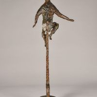 Alt text: Bronze sculpture of a circus performer riding a tall unicycle