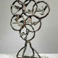 Alt text: Bronze sculpture of birds in circles