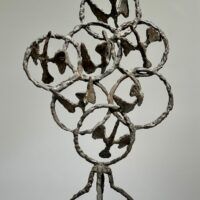 Alt text: Bronze sculpture of birds in circles