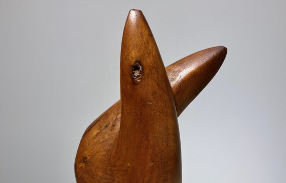 Alt text: Smooth wooden abstract sculpture