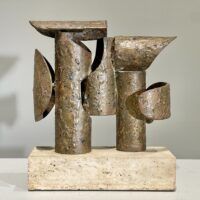 Alt text: Abstract steel and bronze sculpture