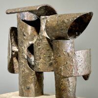 Alt text: Abstract steel and bronze sculpture