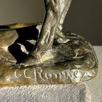 Alt text: Signature detail of a bronze sculpture