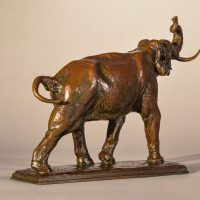 Alt text: Bronze sculpture of a trumpeting elephant, angled view