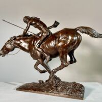 Alt text: Bronze sculpture of a Native American man on horseback